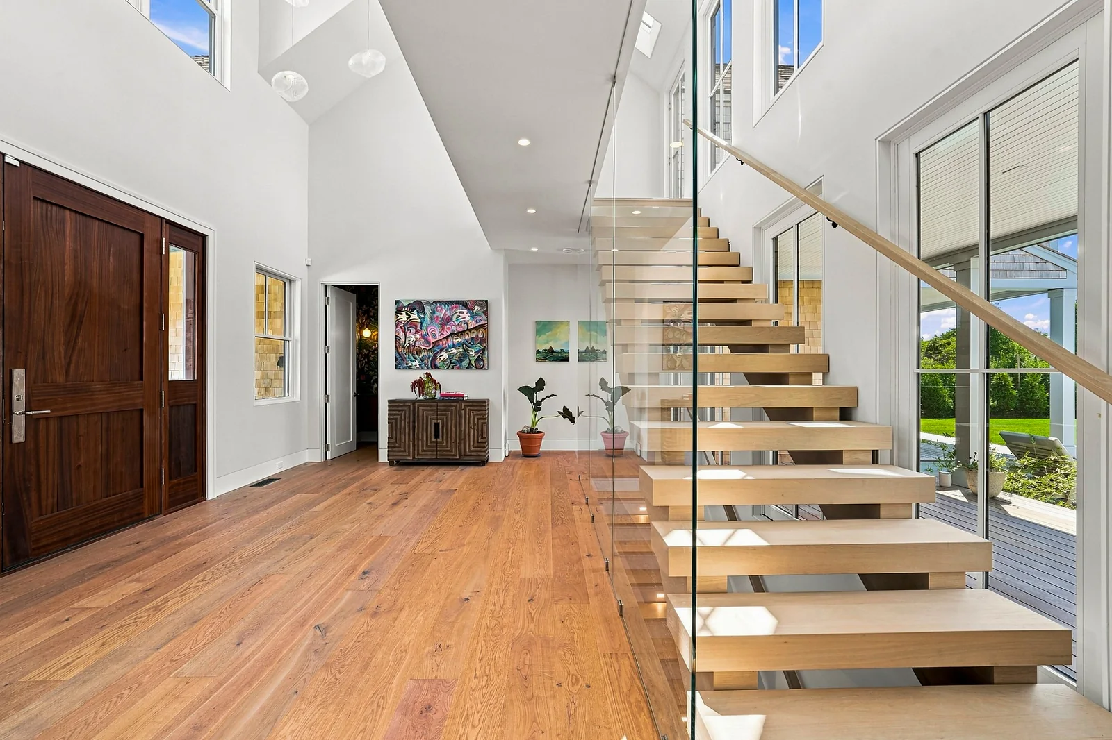 Double-height foyer with floating oak stair