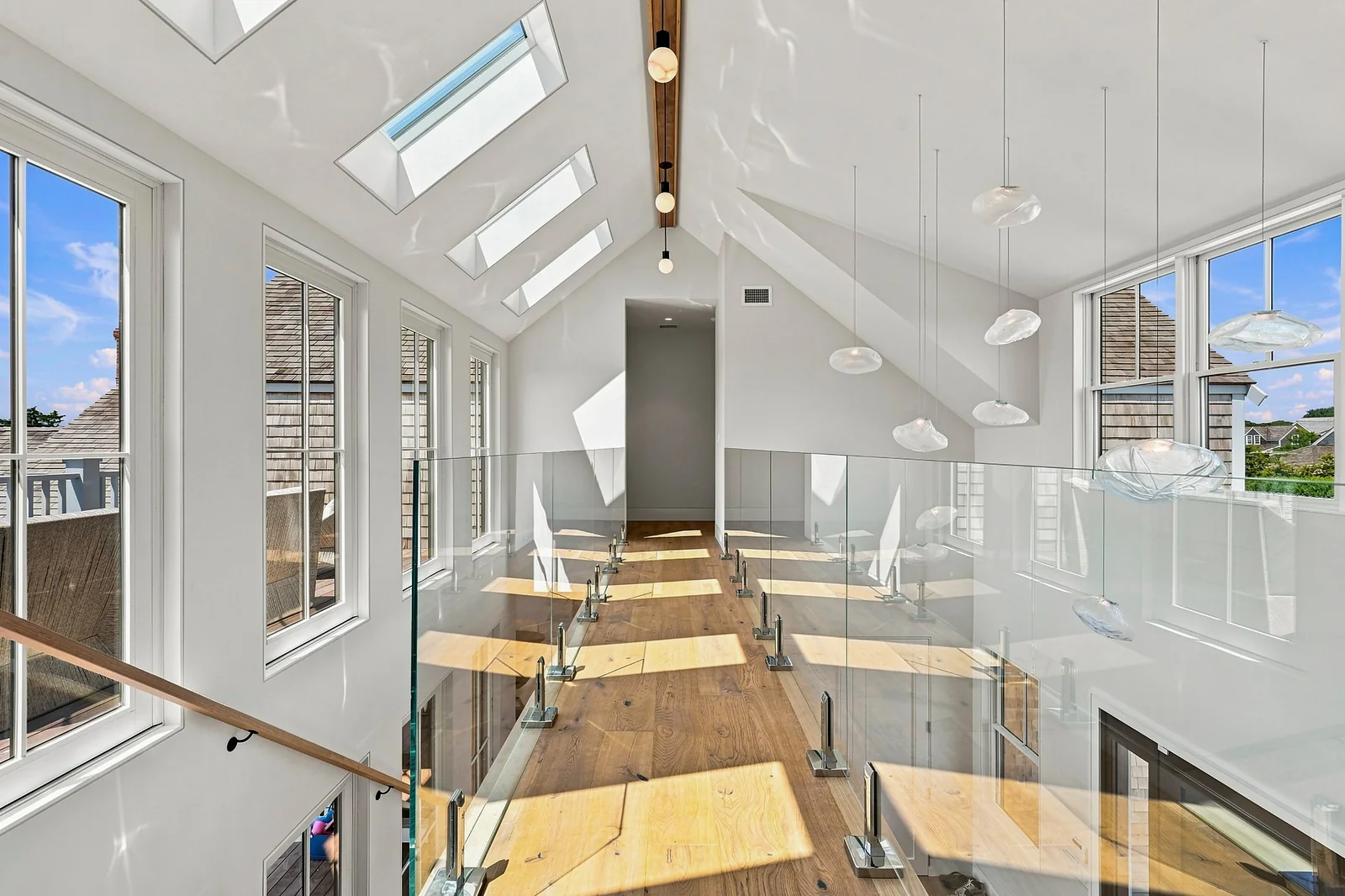 Skylit upper hall with glass railings
